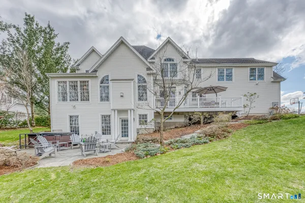 a view of a patio with table and chairs and wooden floor