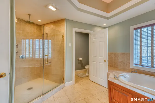 a spacious bedroom with a bed and a window