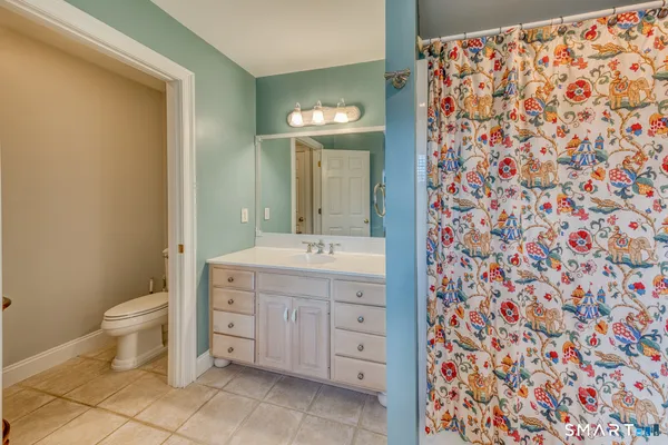 a bedroom with a bed a couch and a window