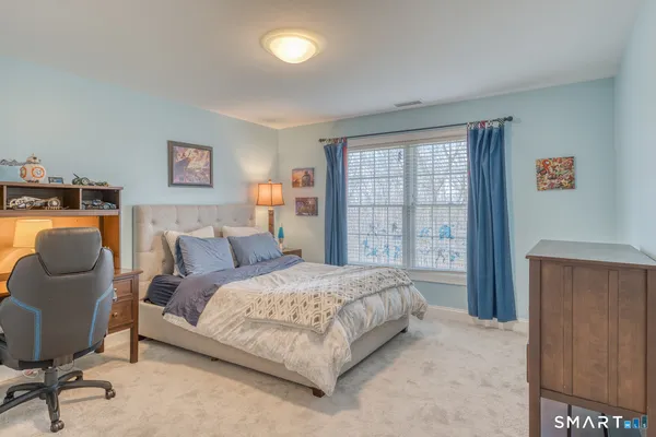 a bedroom with a bed and a view of kitchen
