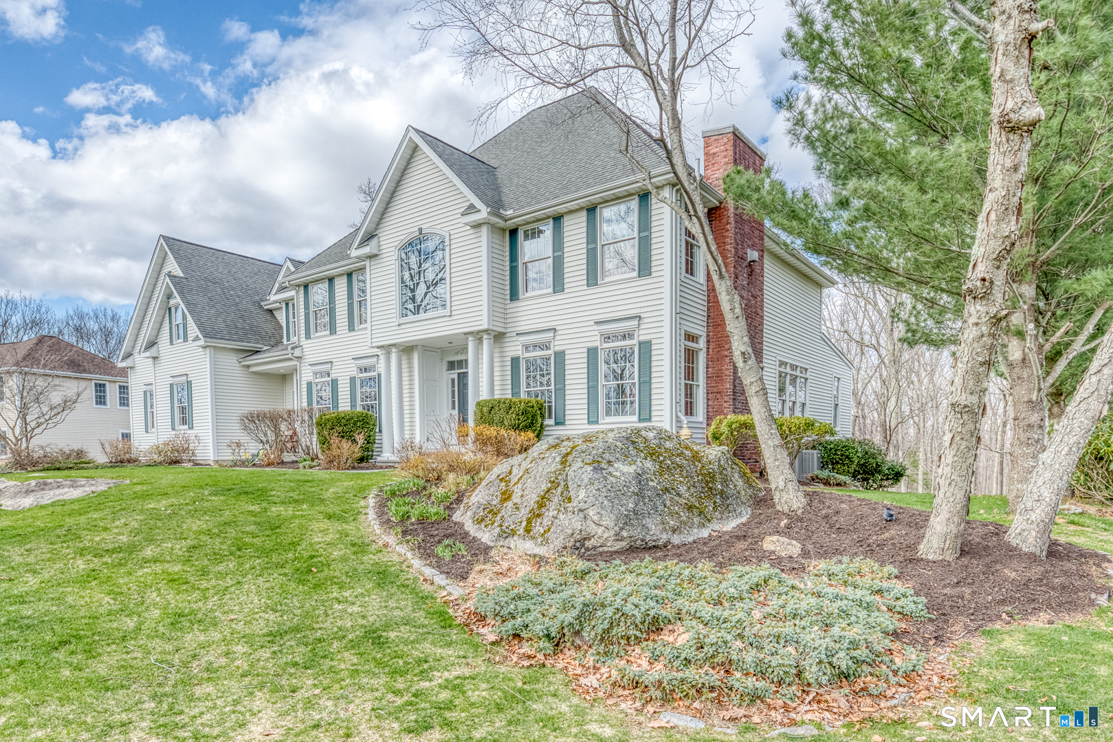 133 Feldspar Ridge Glastonbury, CT 06033 - Photo 5 of 56 a view of a white house next to a yard with big trees
