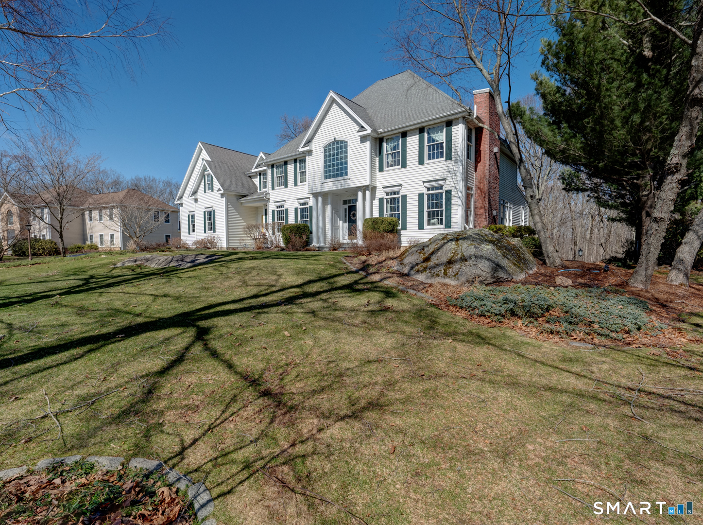 133 Feldspar Ridge Glastonbury, CT 06033 - Photo 6 of 56 a view of a white house next to a yard with large trees