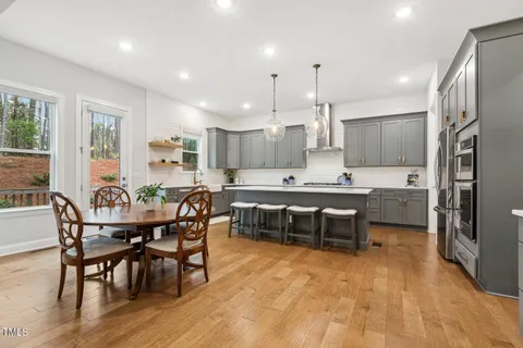 a view of a dining room with furniture and chandelier