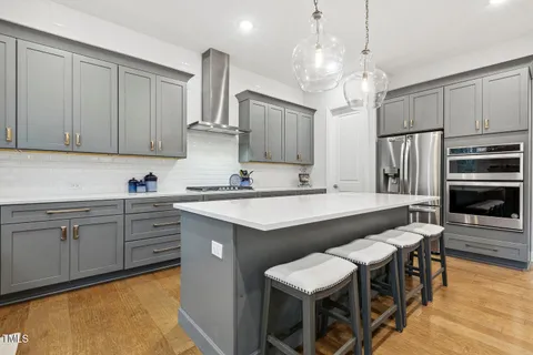 a living room with furniture a fireplace and a large mirror
