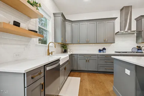 a living room with furniture kitchen view and a large window
