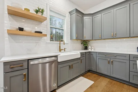 a living room with furniture a fireplace and a chandelier