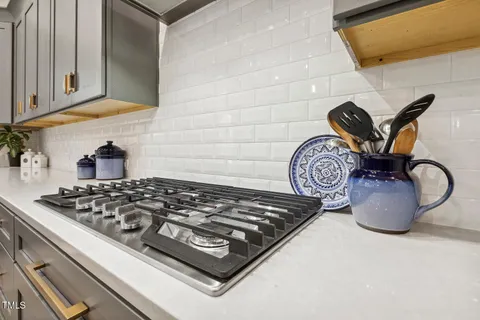a kitchen with stainless steel appliances a cabinets and a stove top oven