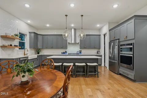 a spacious bedroom with a bed and dresser