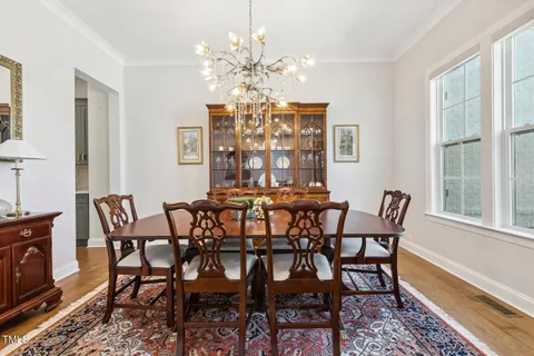 a bathroom with a sink a toilet a mirror and shower curtain