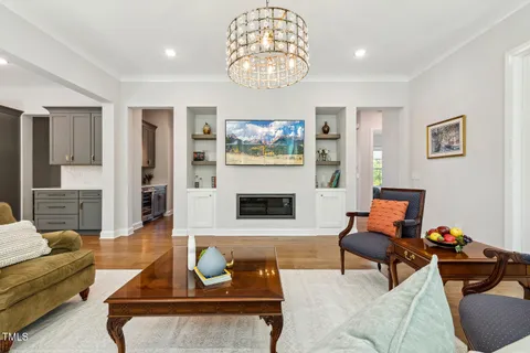 a view of a garden and deck with table and chairs potted plants with wooden floor and fence