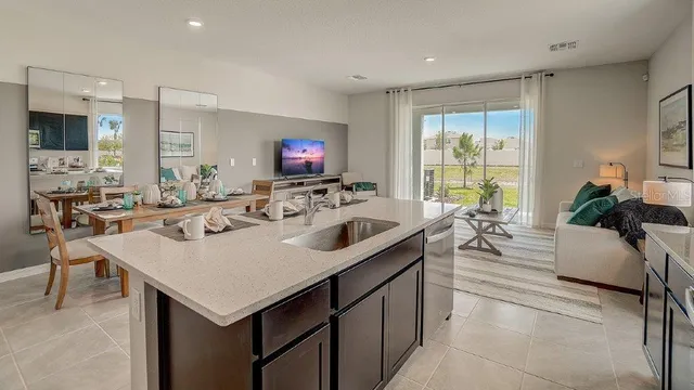 a kitchen with a sink a counter and chairs