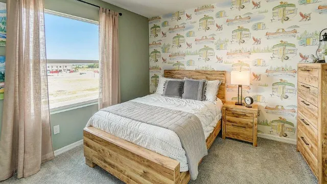 a bedroom with a bed and a window