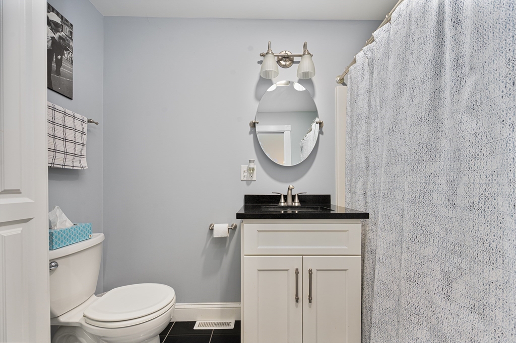 267 Lincoln Avenue Fall River, MA 02720 - Photo 20 of 41 a bathroom with a granite countertop toilet sink and mirror