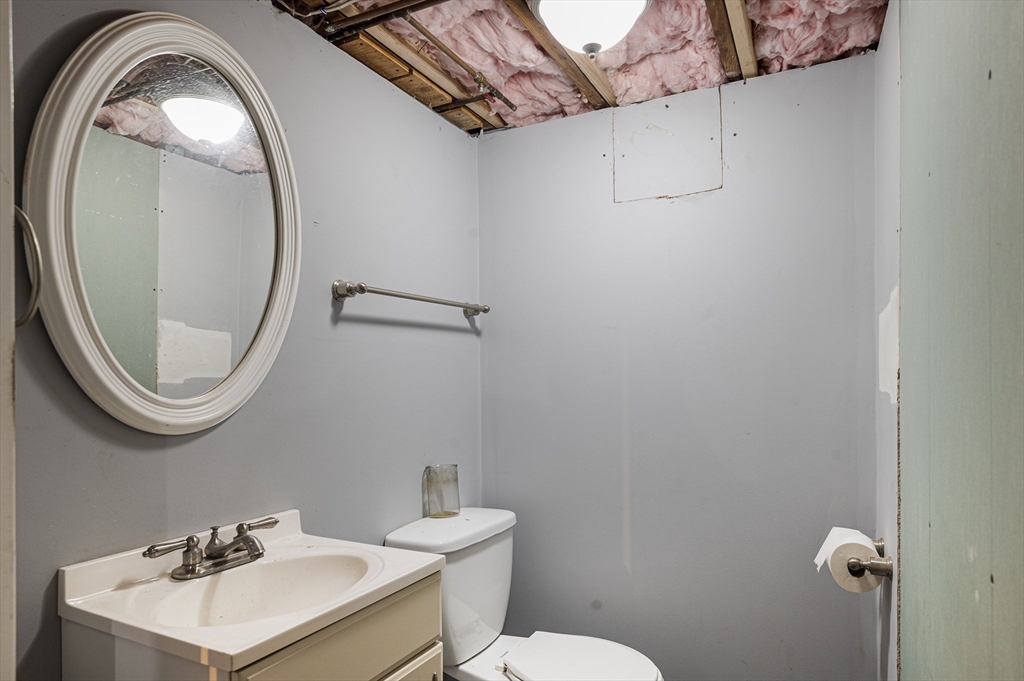 267 Lincoln Avenue Fall River, MA 02720 - Photo 39 of 41 a bathroom with a toilet a sink and mirror