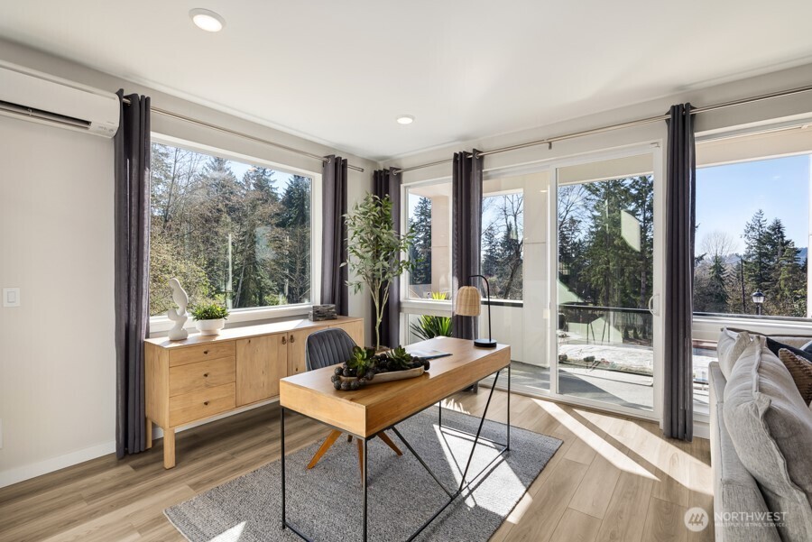 4249 Aberdeen Way Northeast Renton, WA 98056 - Photo 19 of 38 a workspace with wooden floor and a floor to ceiling window