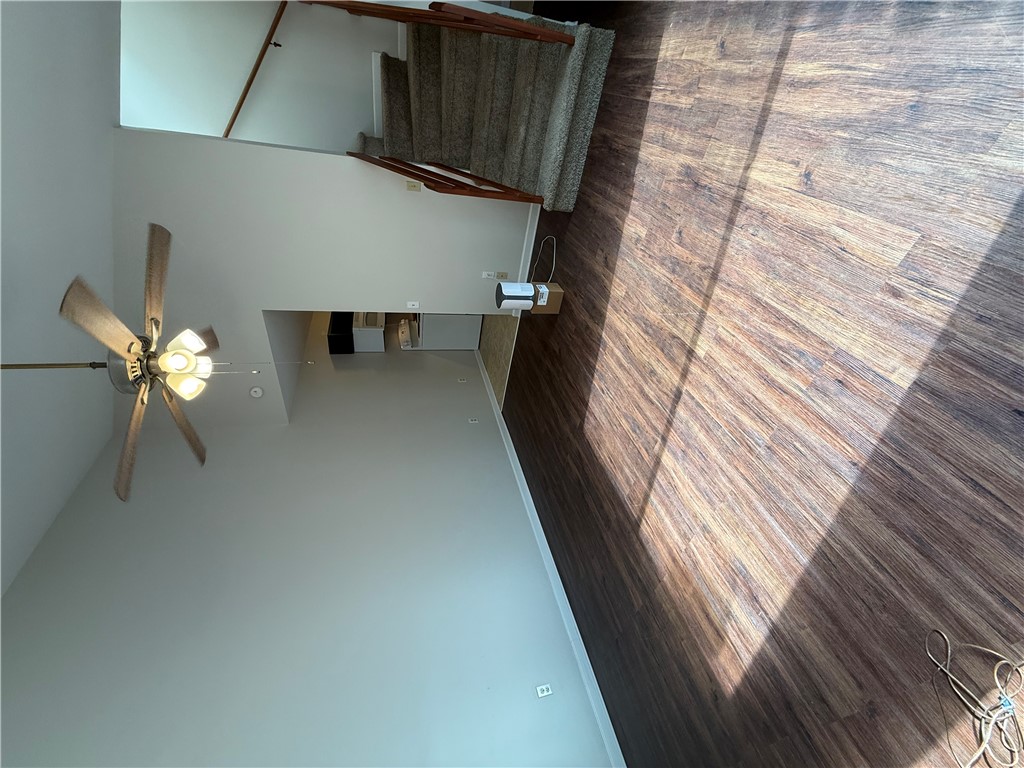 125 Maple Street, Unit 110 Pendleton, SC 29670 - Photo 18 of 18 In the living room-dining room combination, hardwood-style flooring extends from the living space to the carpeted staircase, creating a cohesive flow and easy to maintain