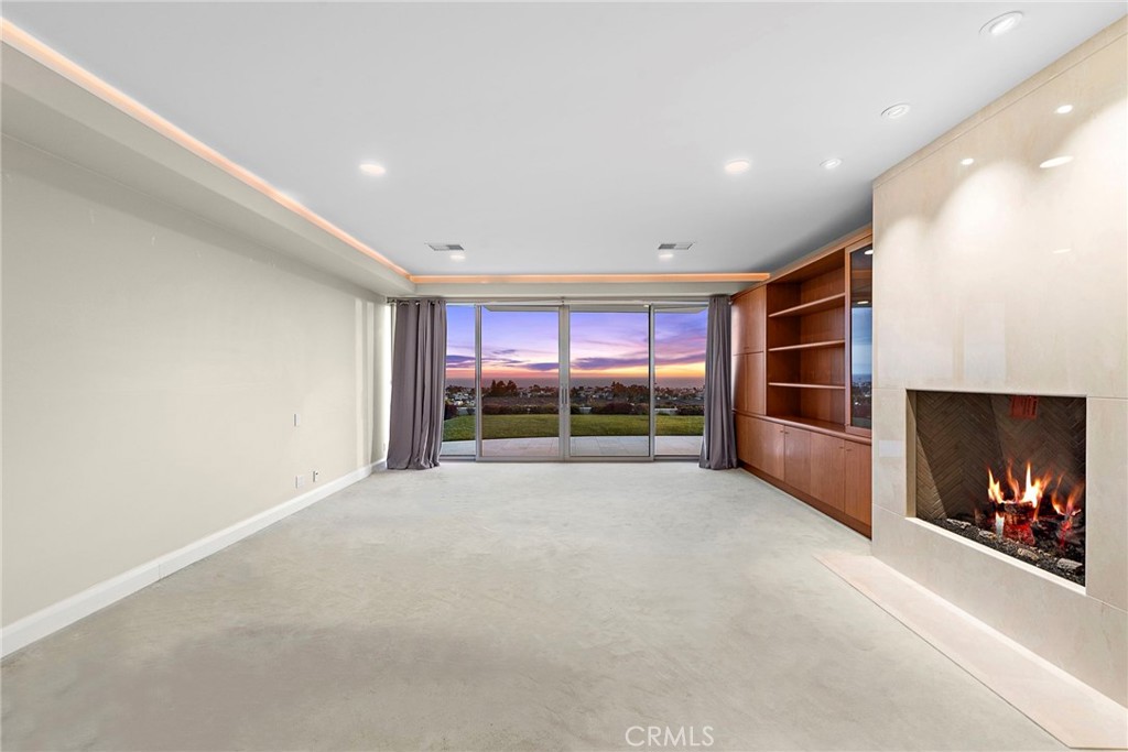 2801 Setting Sun Drive Corona del Mar, CA 92625 - Photo 15 of 30 a view of an empty room with a fireplace and a window