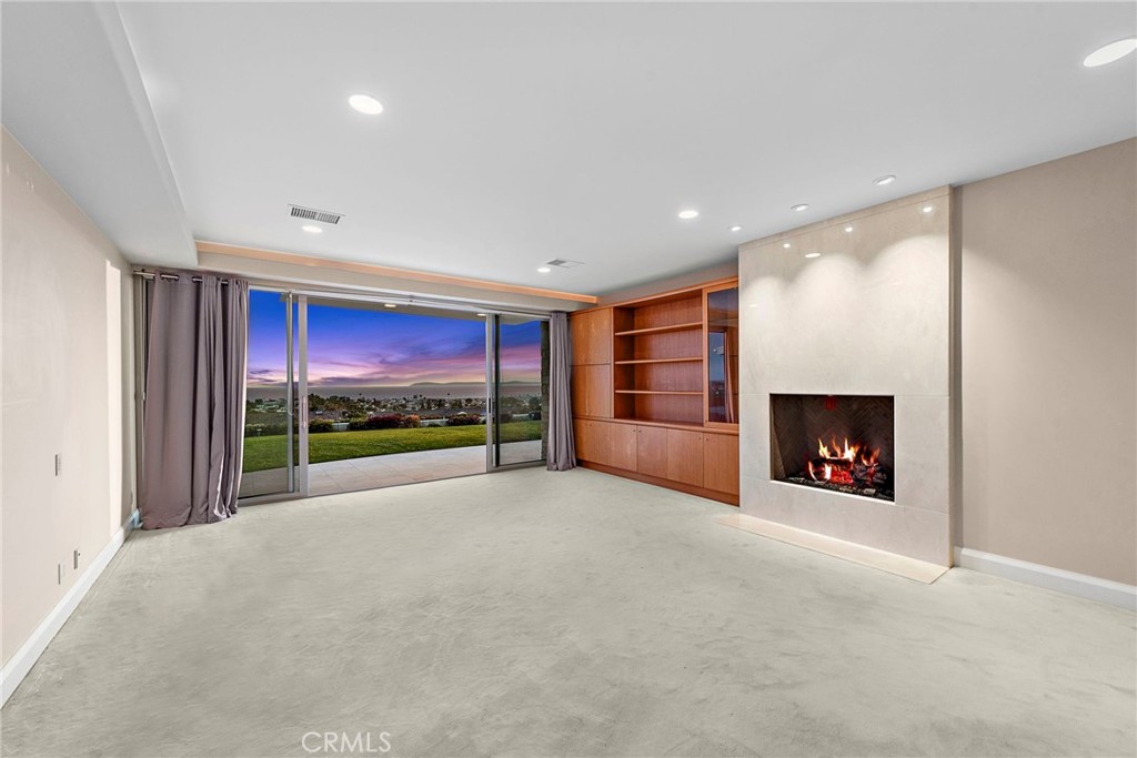 2801 Setting Sun Drive Corona del Mar, CA 92625 - Photo 16 of 30 a view of an empty room with a fireplace and a fireplace