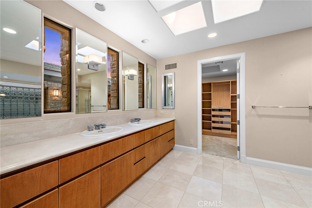 2801 Setting Sun Drive Corona del Mar, CA 92625 - Photo 17 of 30 a spacious bathroom with double vanity and a large mirror