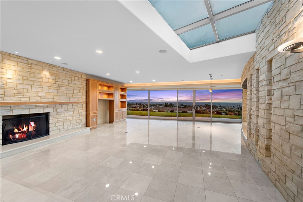 2801 Setting Sun Drive Corona del Mar, CA 92625 - Photo 5 of 30 a view of an empty room with a fireplace