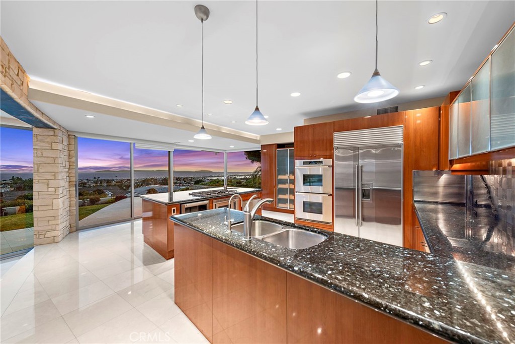 2801 Setting Sun Drive Corona del Mar, CA 92625 - Photo 8 of 30 a kitchen with stainless steel appliances granite countertop a sink a oven and a view of living room