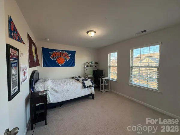 a bedroom with furniture and a window