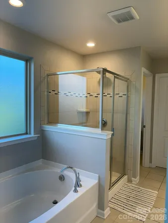 a bathroom with a bathtub and shower