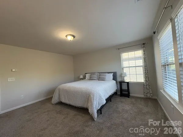 a bed room with a bed and a window