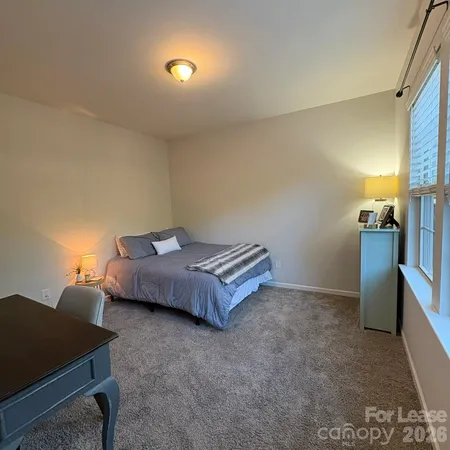 a living room with furniture and a lamp