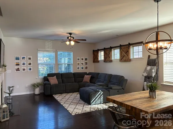 a living room with furniture and a chandelier