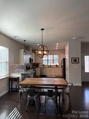 a room with pool table and windows