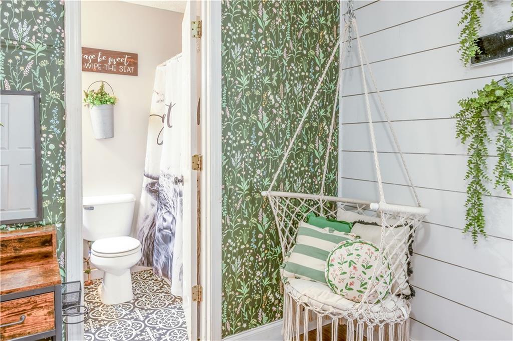 1280 Ragan Road Douglasville, GA 30134 - Photo 24 of 33 a bathroom with a toilet and a shower curtain