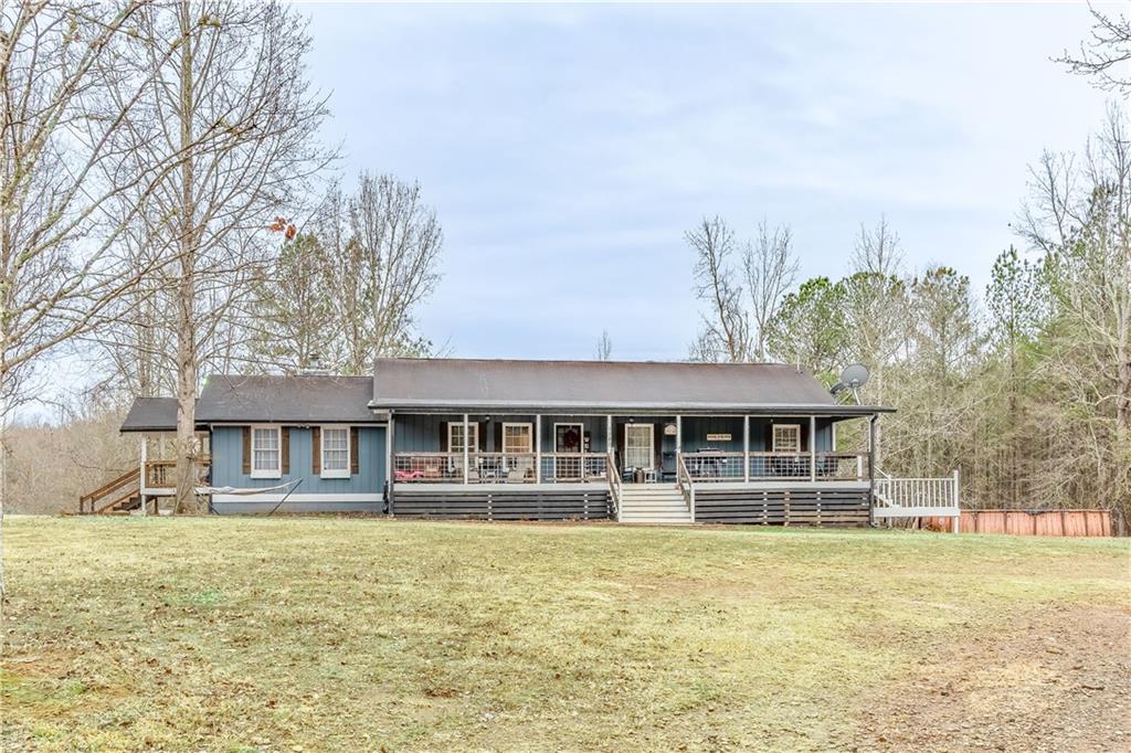 1280 Ragan Road Douglasville, GA 30134 - Photo 5 of 33 a front view of a house with a big yard