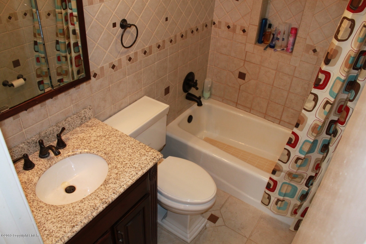 1449 Clover Road Long Pond, PA 18334 - Photo 9 of 29 a bathroom with a granite countertop sink toilet and shower