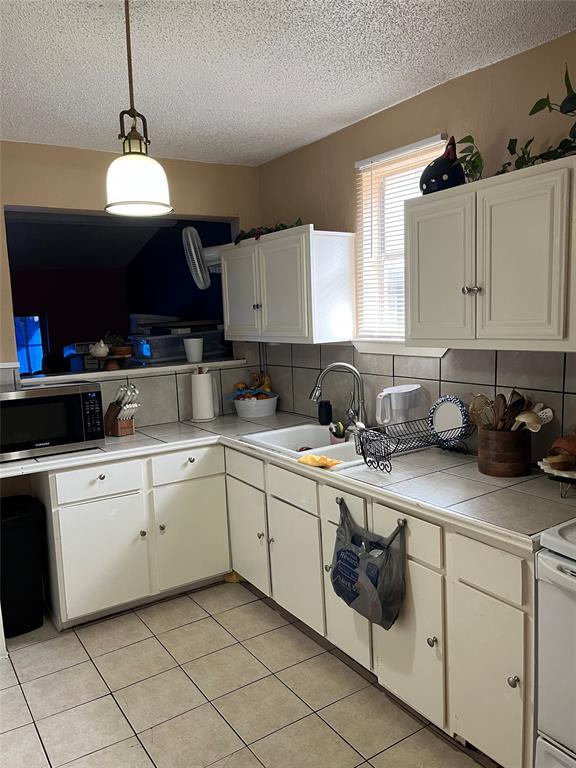 3610 Bertrand Avenue Dallas, TX 75210 - Photo 8 of 10 a kitchen with cabinets appliances and a window