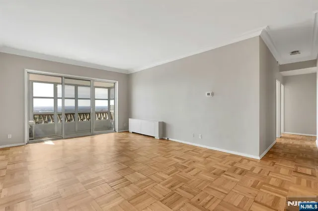 a view of an empty room with glass door