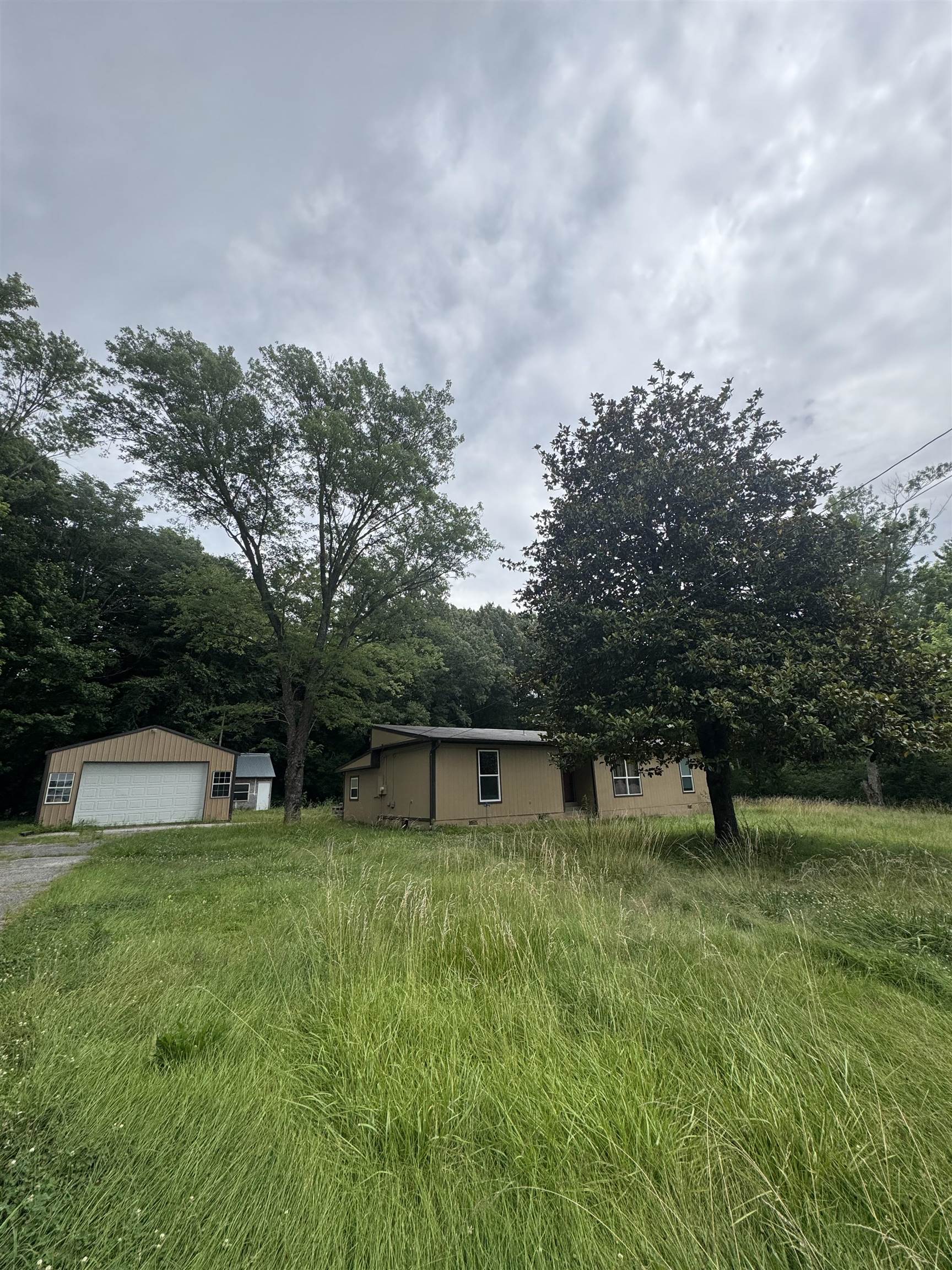 106 Cole Road Drummonds, TN 38023 - Photo 3 of 21 Single-story residence with a light brown facade and white-framed windows