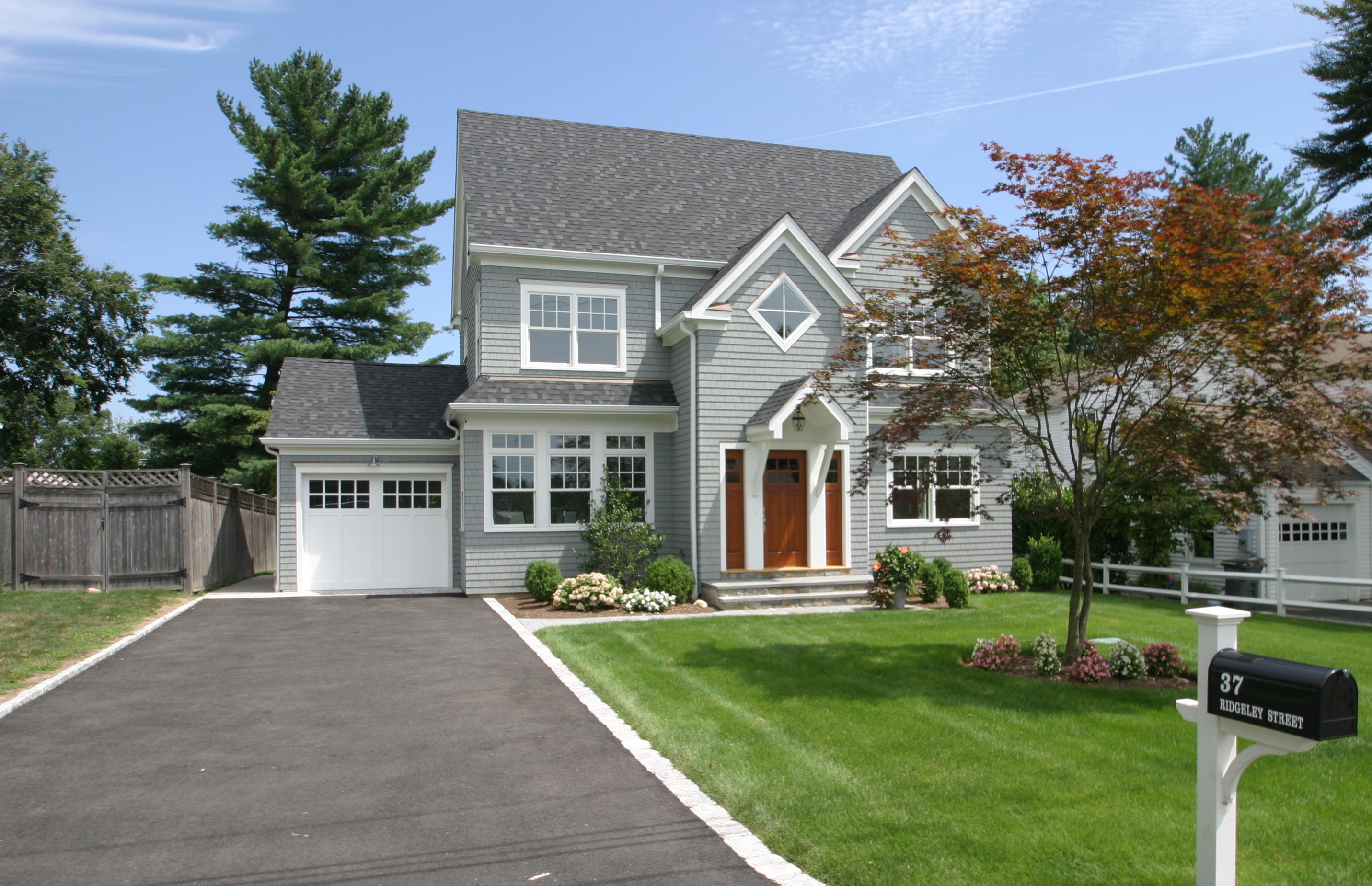 37 Ridgeley Street Darien, CT 06820 - Photo 1 of 24 a front view of a house with a yard table and chairs