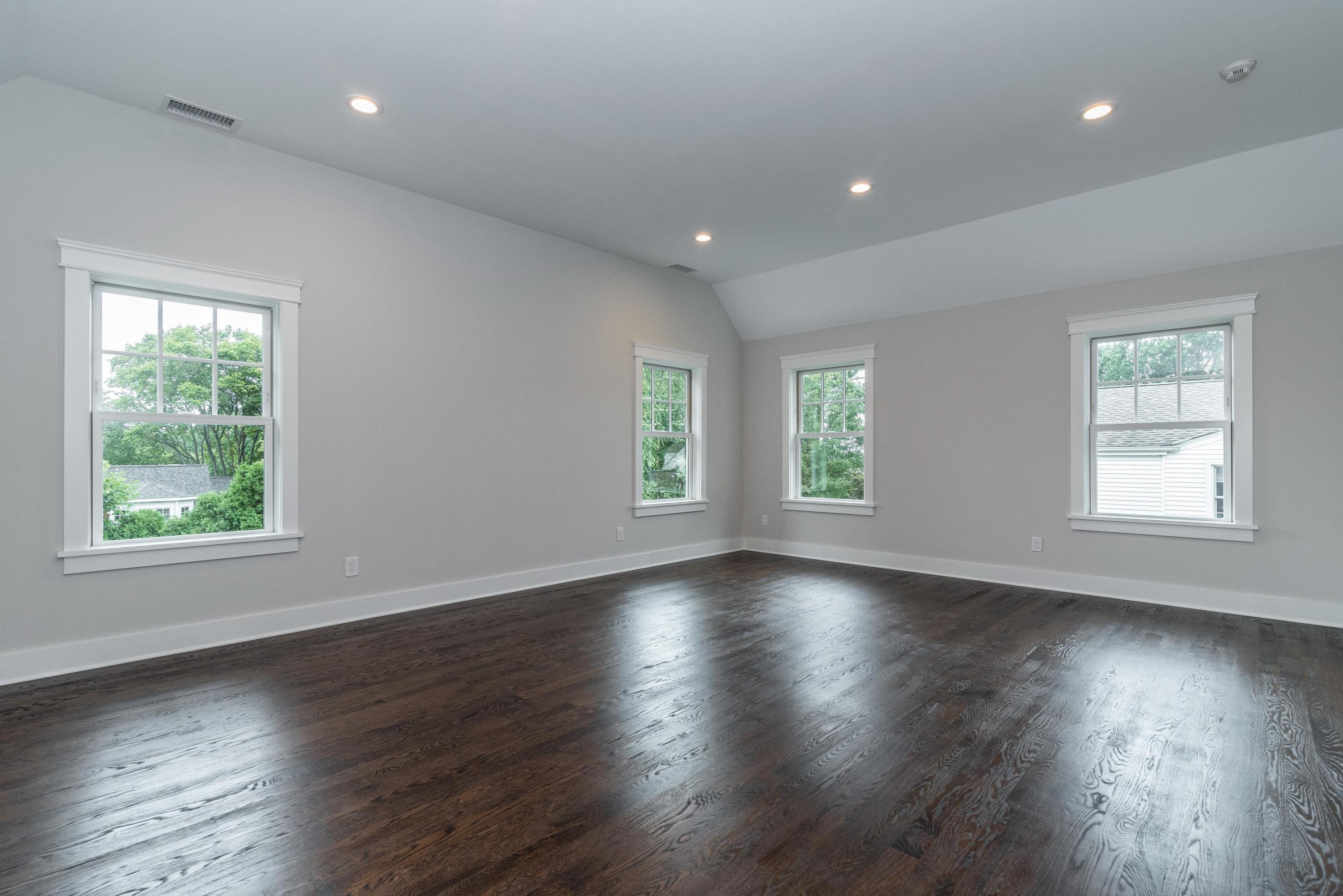 37 Ridgeley Street Darien, CT 06820 - Photo 11 of 24 an empty room with wooden floor and windows
