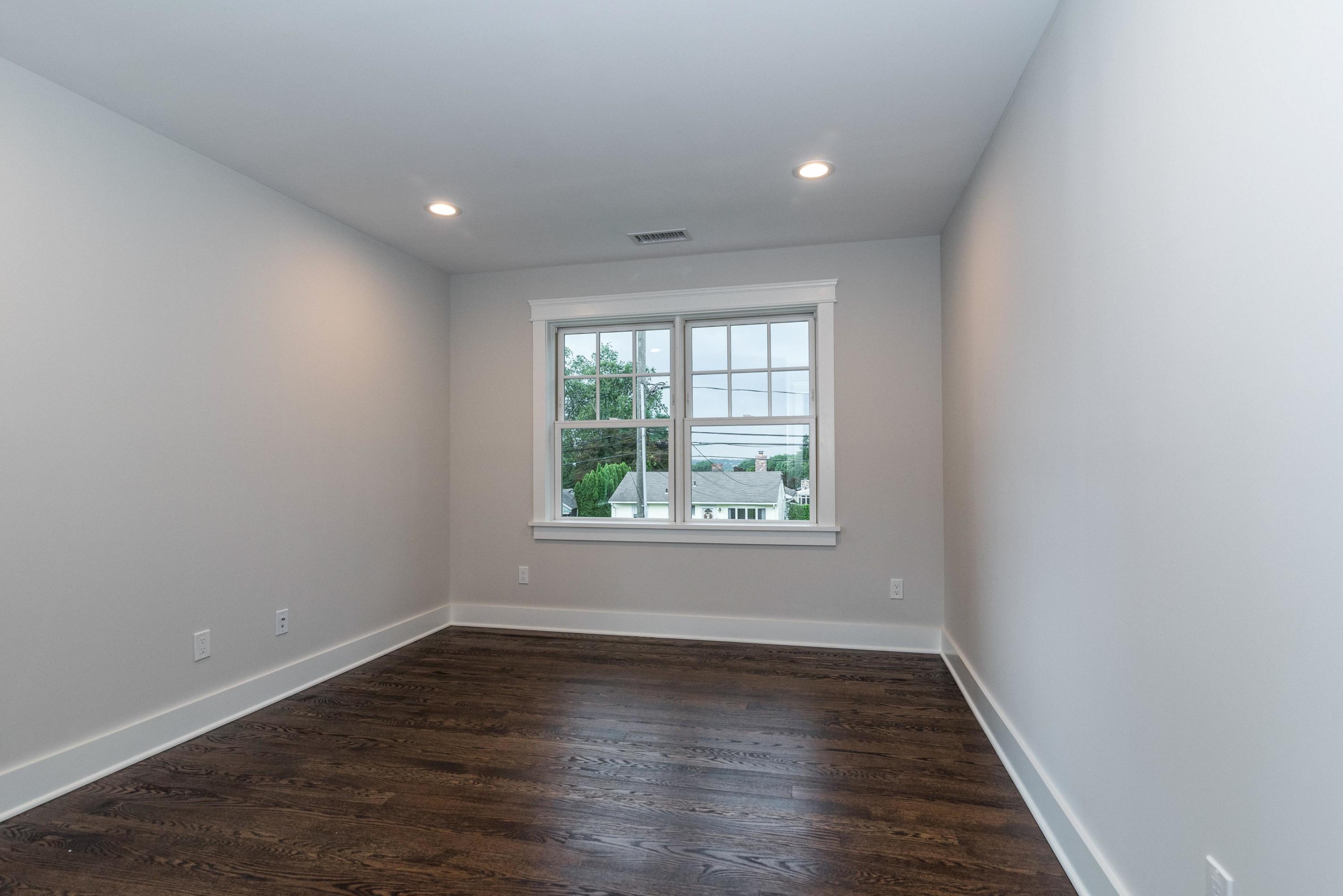 37 Ridgeley Street Darien, CT 06820 - Photo 15 of 24 an empty room with wooden floor and windows