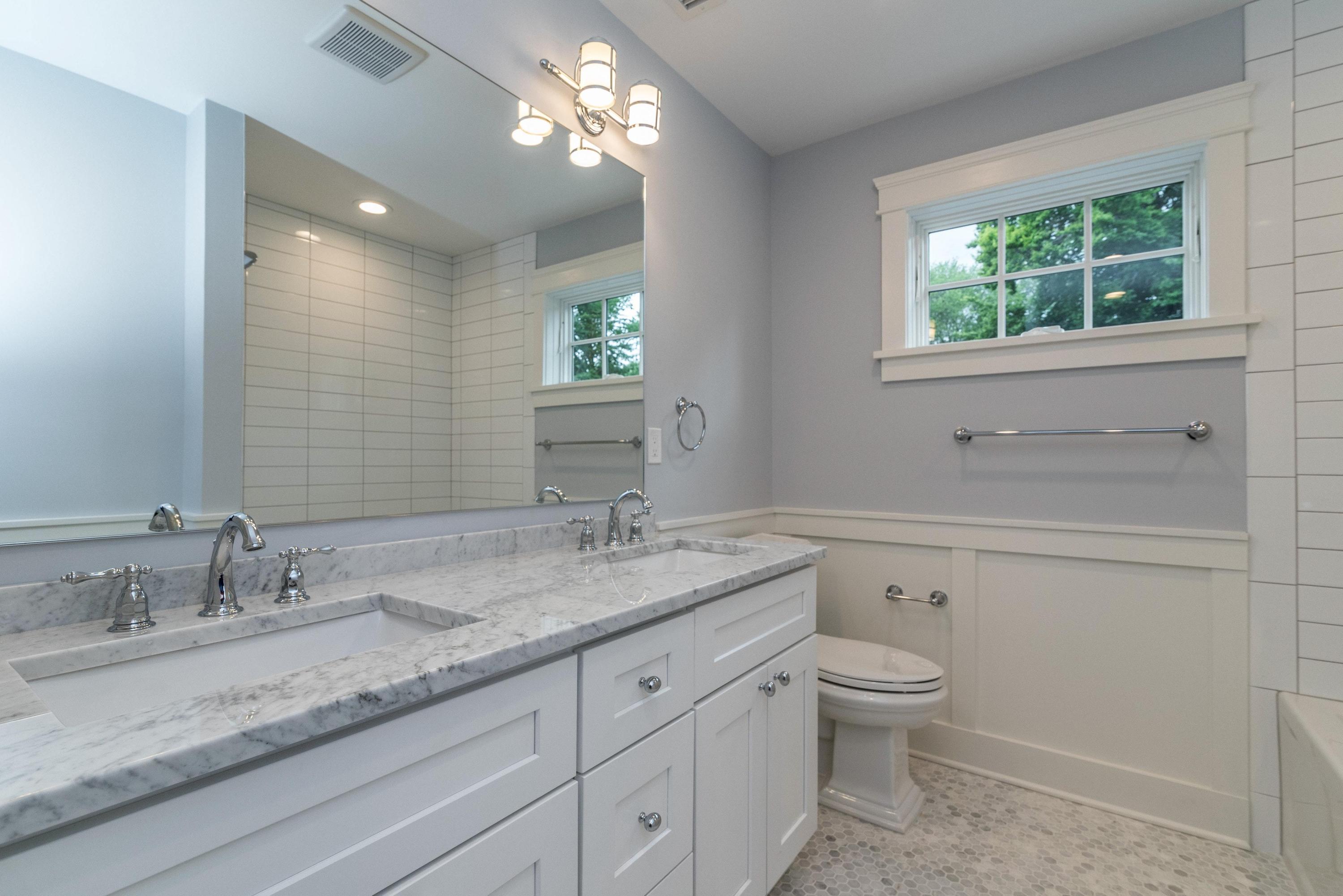 37 Ridgeley Street Darien, CT 06820 - Photo 16 of 24 a bathroom with a granite countertop toilet a sink a mirror and a window