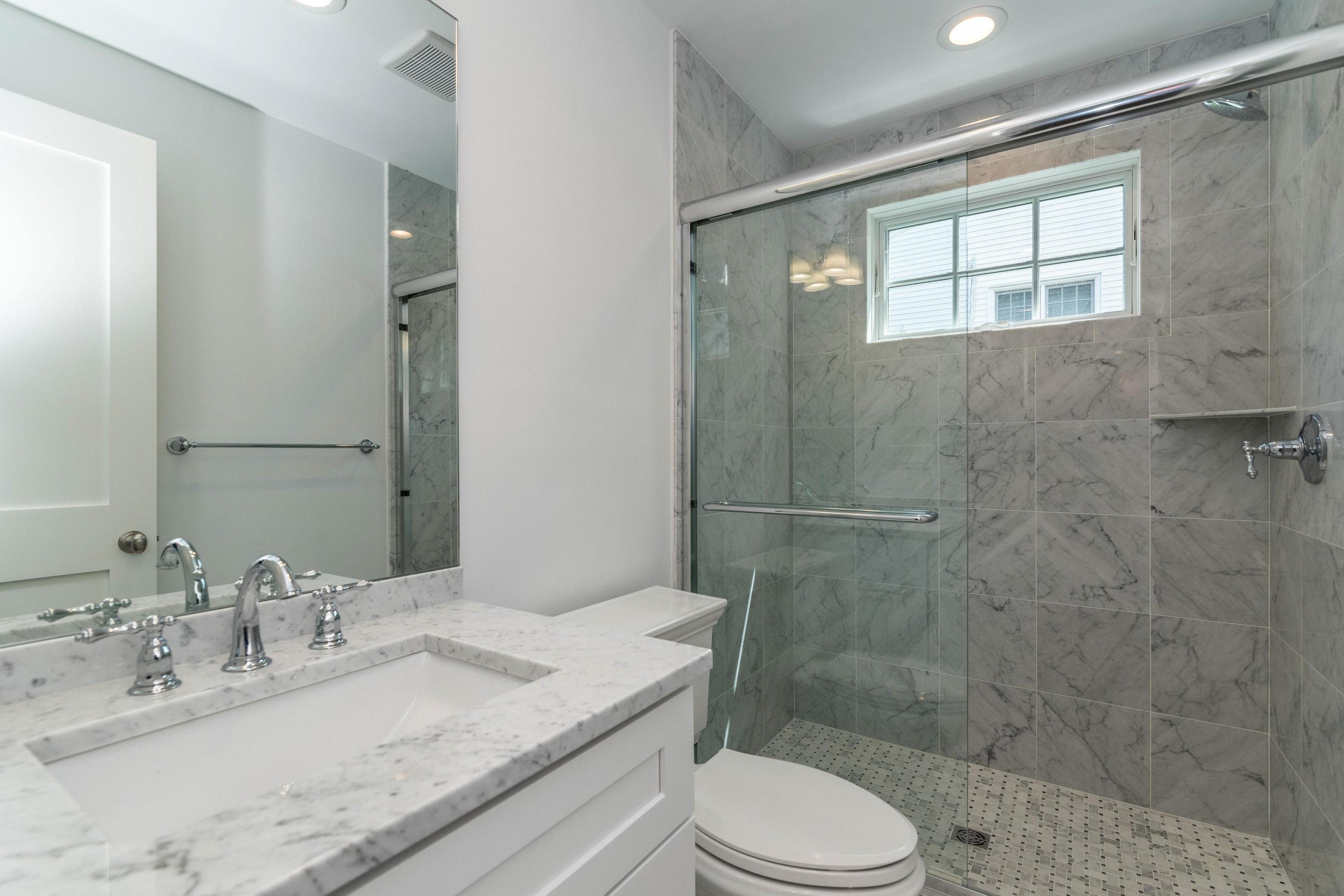 37 Ridgeley Street Darien, CT 06820 - Photo 18 of 24 a bathroom with a granite countertop sink toilet a mirror and shower