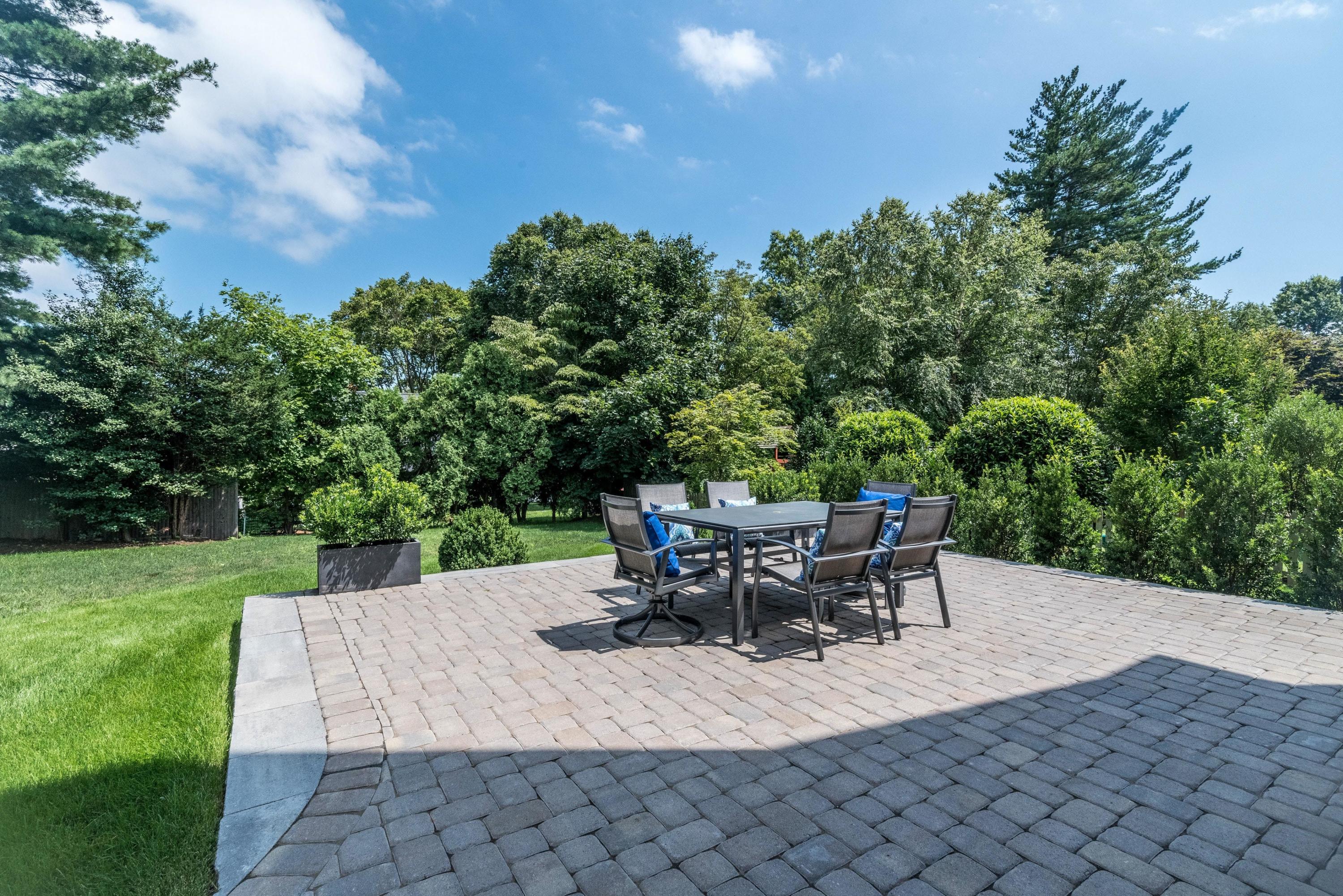 37 Ridgeley Street Darien, CT 06820 - Photo 21 of 24 a view of a patio with table and chairs and potted plants with wooden fence