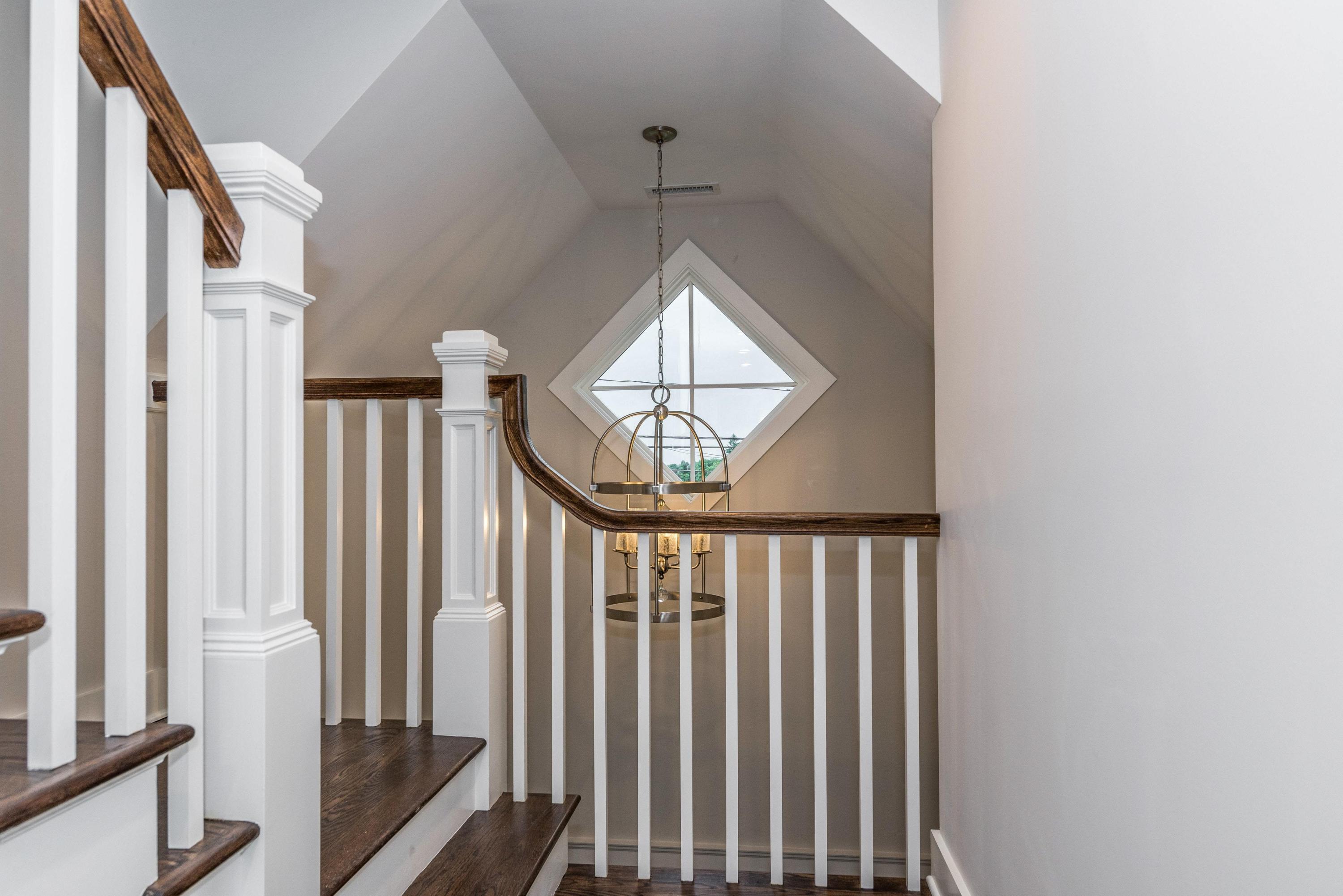 37 Ridgeley Street Darien, CT 06820 - Photo 10 of 24 a view of staircase with wooden floor and a window