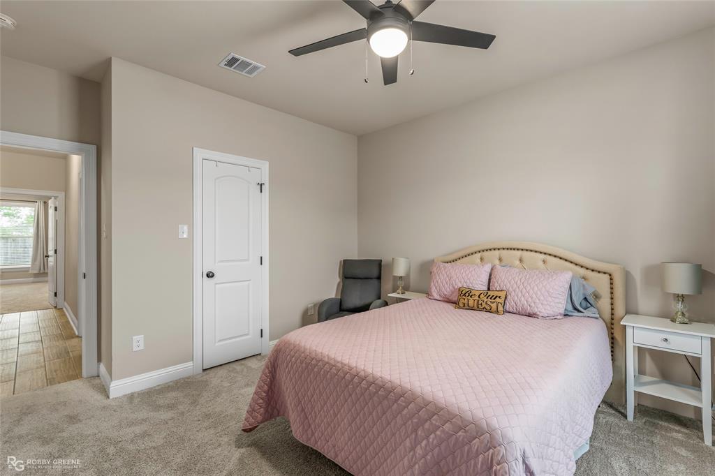 122 Brimestone Loop Benton, LA 71006 - Photo 21 of 33 a bedroom with a large bed and a chandelier