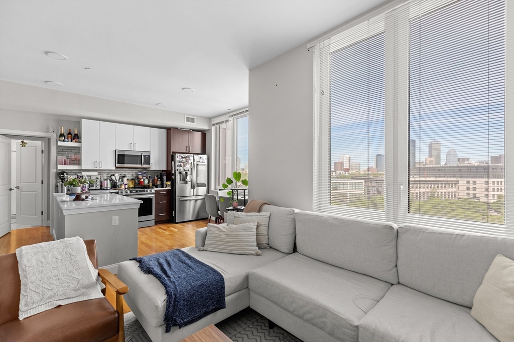 10 Taber Street, Unit 508 Boston, MA 02119 - Photo 4 of 11 a living room with furniture and a large window