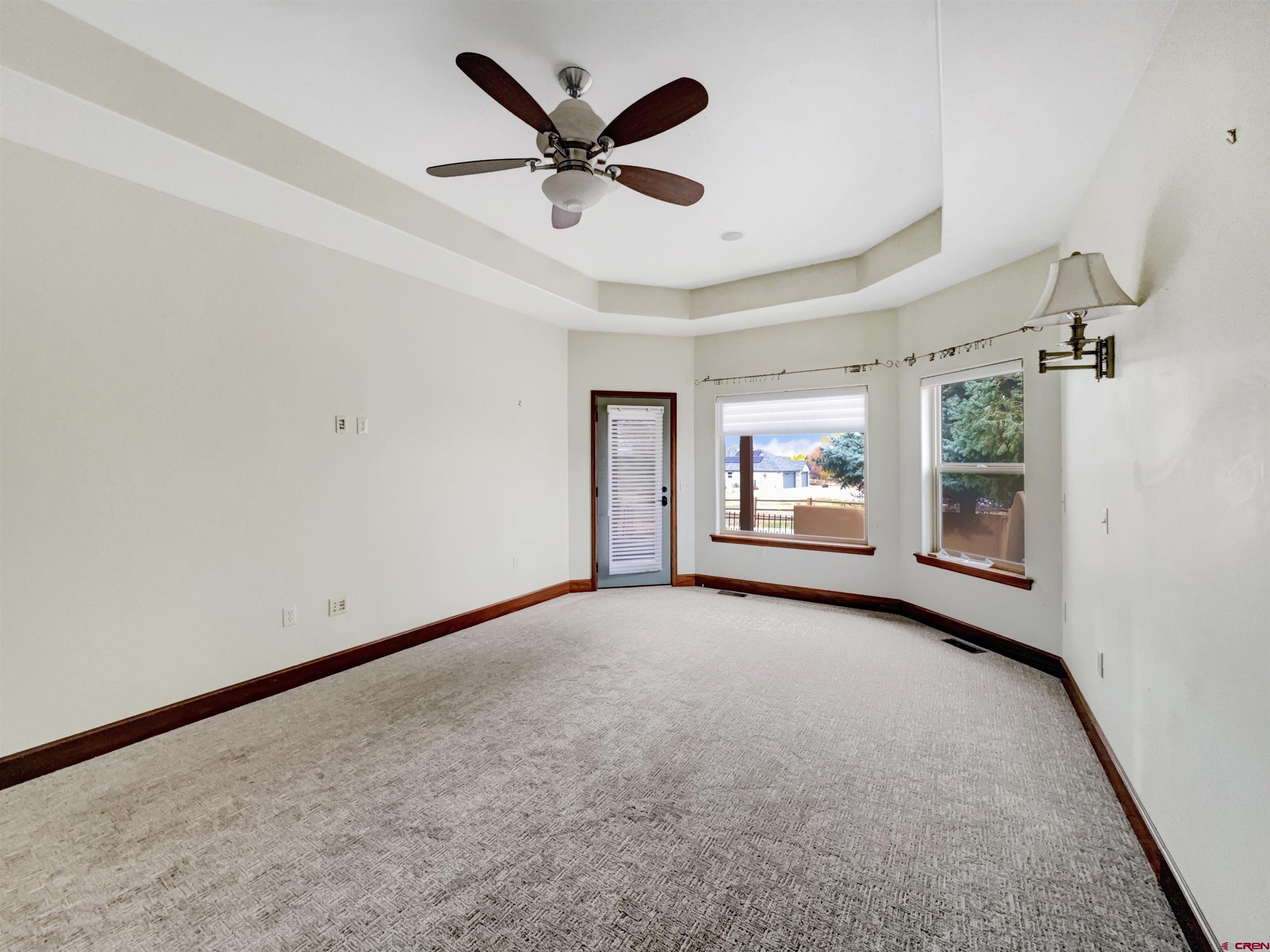 1794 Roubideau Street Delta, CO 81416 - Photo 11 of 35 an empty room with ceiling fan and windows
