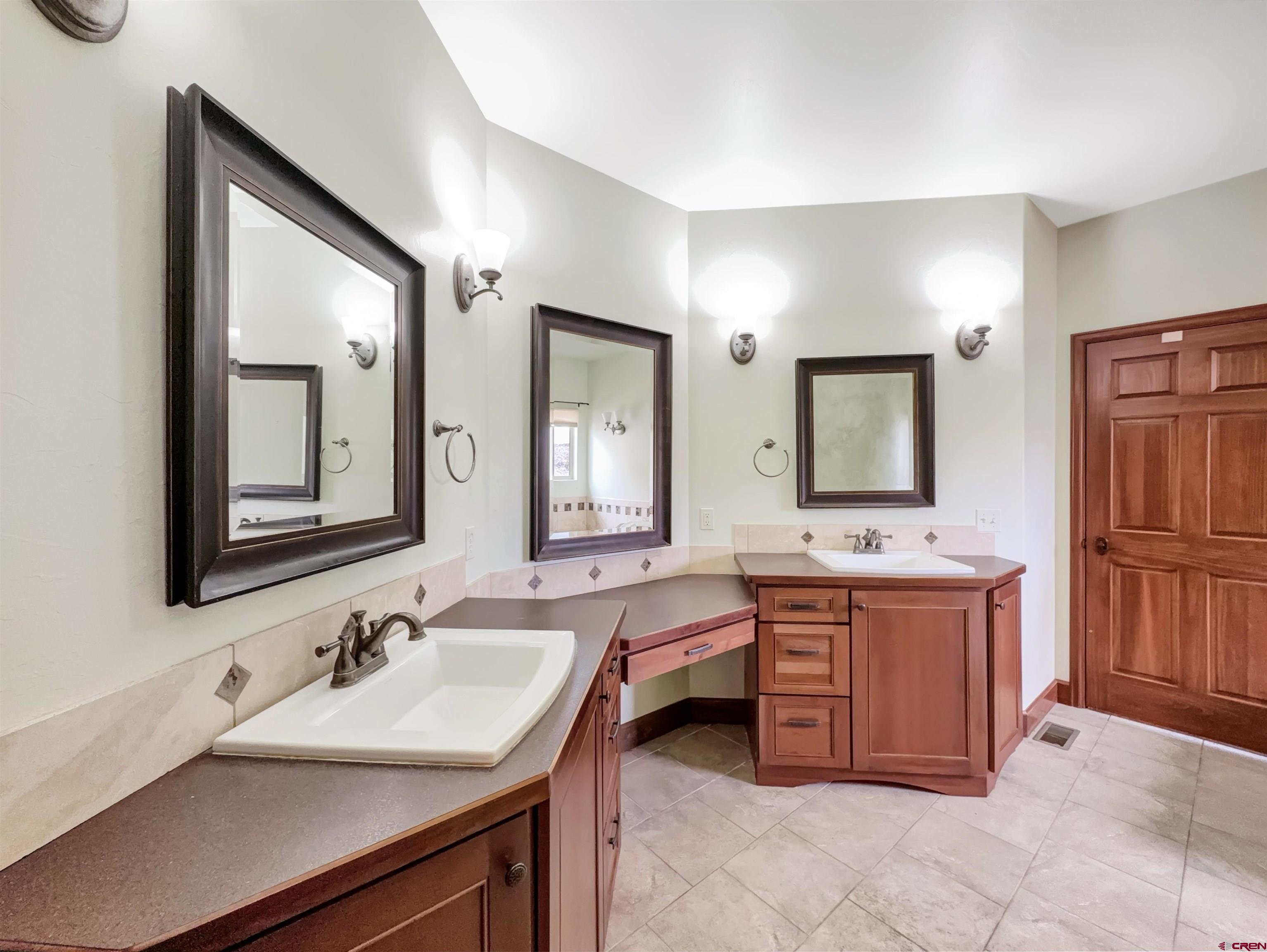 1794 Roubideau Street Delta, CO 81416 - Photo 15 of 35 a bathroom with a sink vanity and mirror