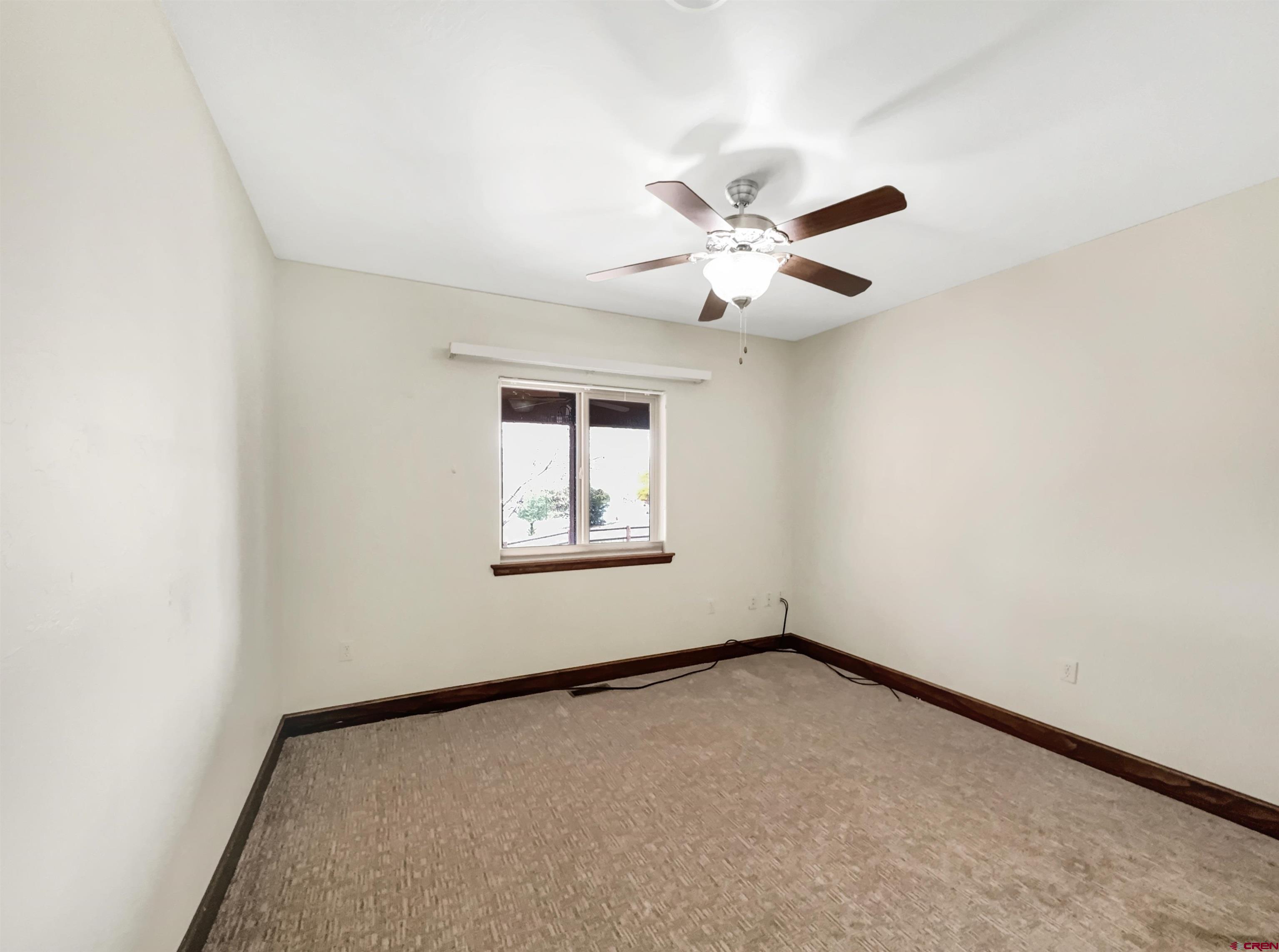 1794 Roubideau Street Delta, CO 81416 - Photo 18 of 35 an empty room with a window and a fan