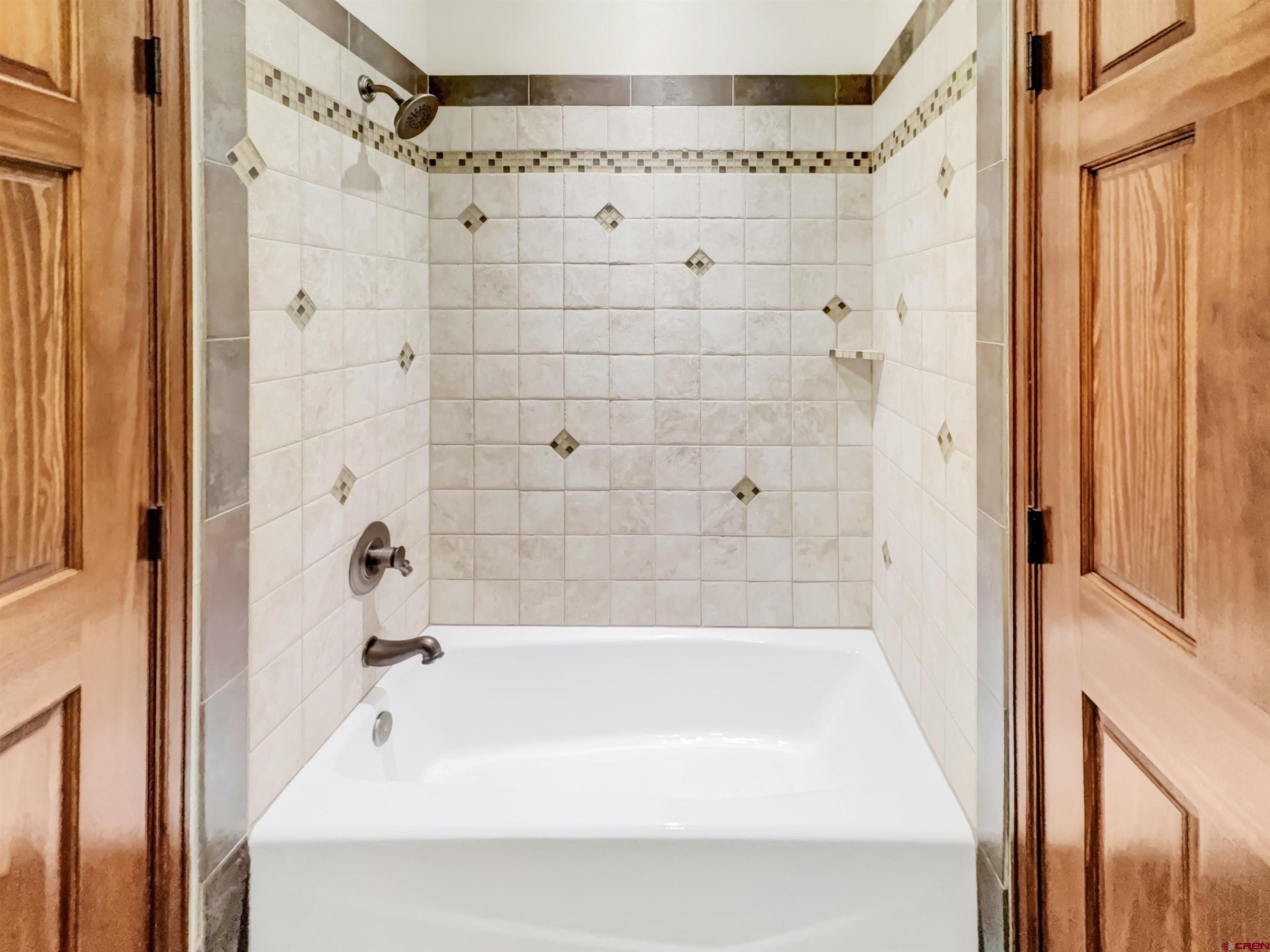 1794 Roubideau Street Delta, CO 81416 - Photo 23 of 35 a bathroom with a bathtub and a shower